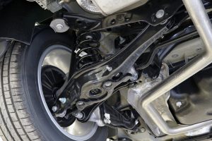 Car suspension components including a coil spring and control arms viewed from underneath