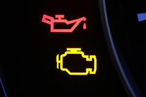 Engine management and oil warning lights illuminated on a vehicle dashboard